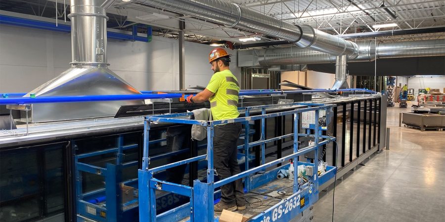Workers installing refrigeration equipment